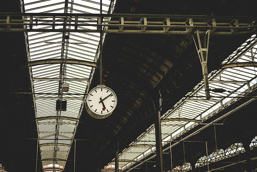 Vintage Clock Hanging in Industrial Train Station Ceiling