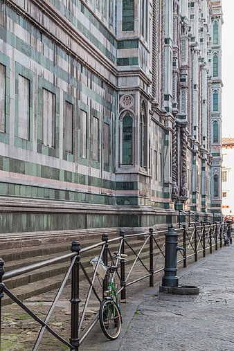 Green bicycle parked near Florence Cathedral facade