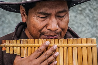 Close-up of Man Playing Bamboo Pan Flute