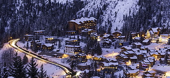 Snowy Alpine Ski Resort Village at Night with Light Trails