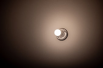 Glowing Exterior Wall Light Fixture at Night