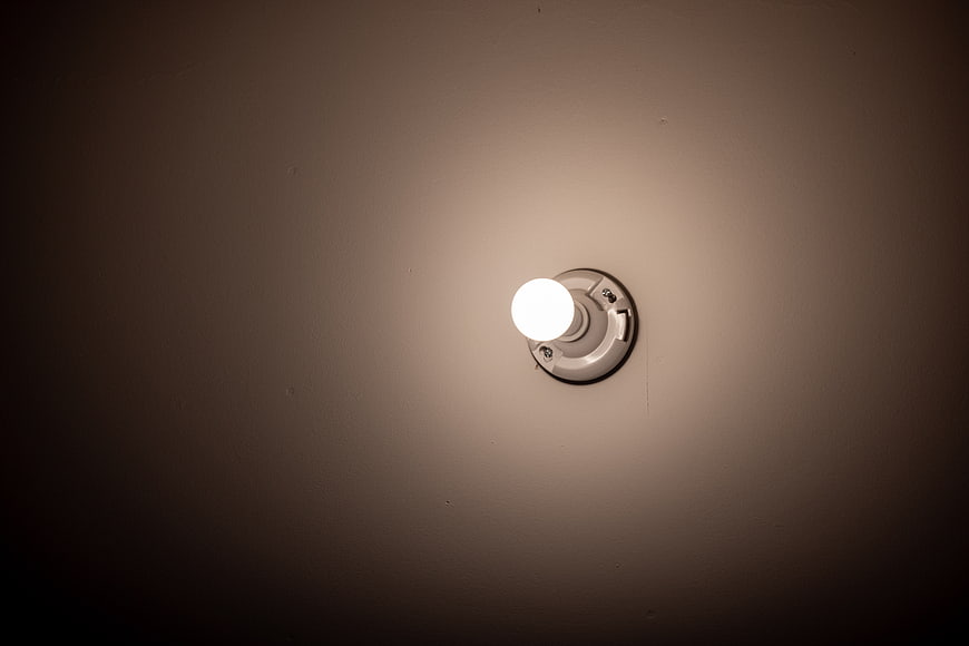Glowing Exterior Wall Light Fixture at Night