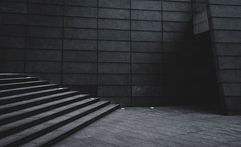 Dark minimalist stone staircase and textured wall architecture