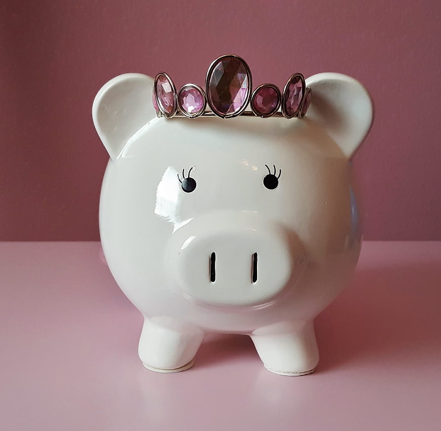 White Piggy Bank with Pink Tiara on Pink Background