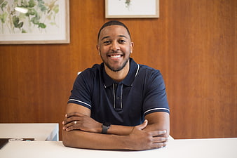 Smiling African American Man Sitting at Desk in Office