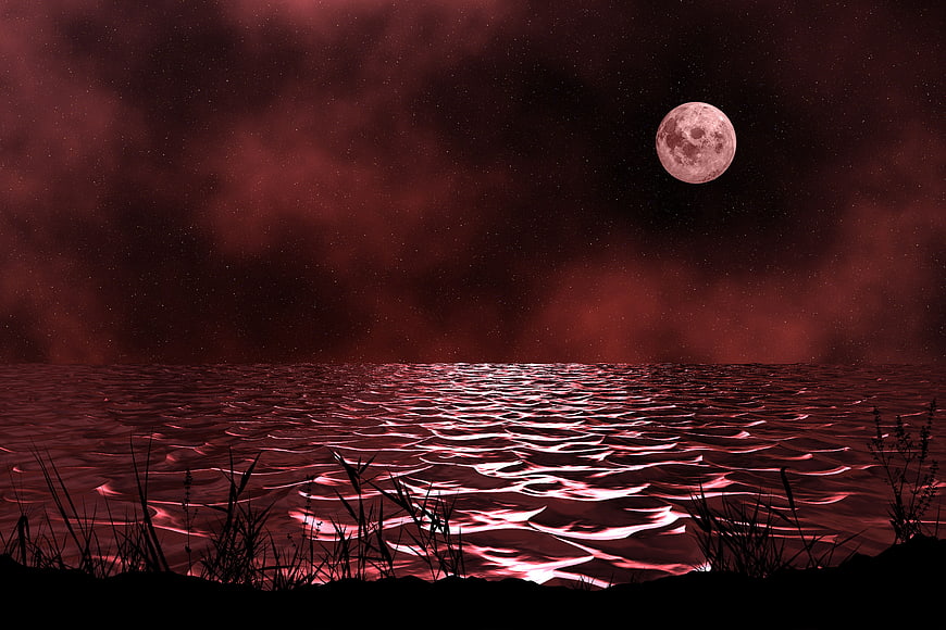 Dramatic Red Moon Over Dark Ocean Water