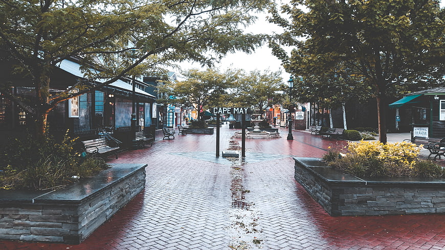 Rainy pedestrian street in Cape May with wet brick pavement