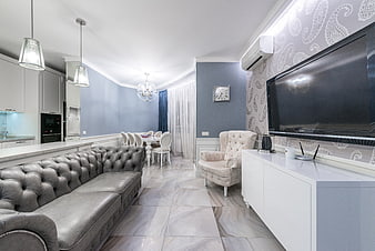 Modern living room with grey leather sofa and blue walls