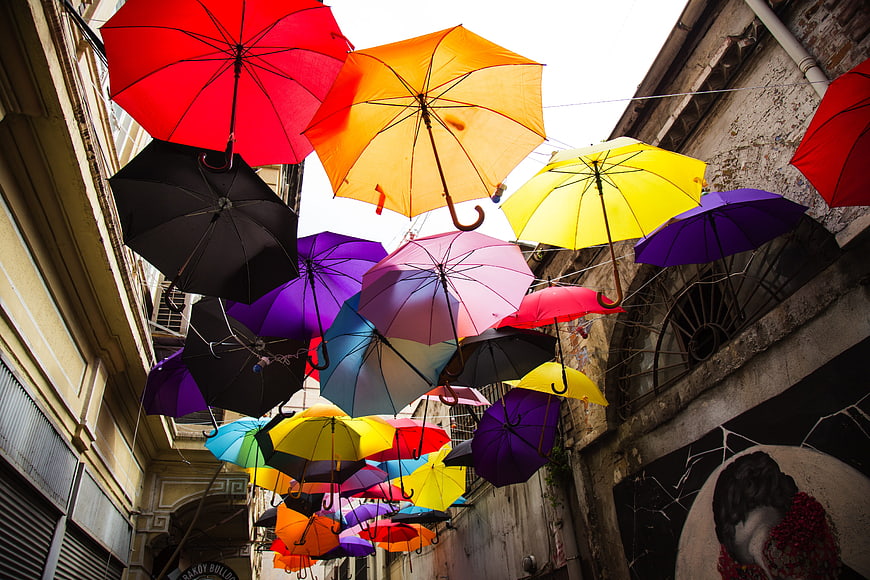 Colorful Umbrellas Hanging Above Historic European Street