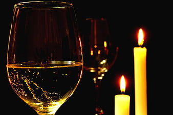 Romantic Candlelit Dinner Setting With White Wine Glasses