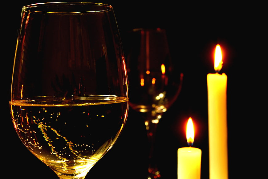 Romantic Candlelit Dinner Setting With White Wine Glasses