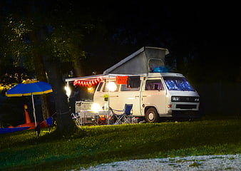 White VW Camper Van Camping at Night with Pop-up Roof
