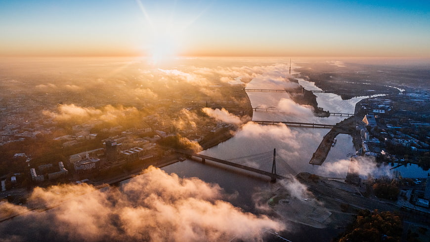 Aerial View of Riga River Bridges at Sunrise with Fog