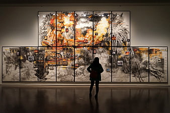 Woman viewing large abstract art installation in museum gallery