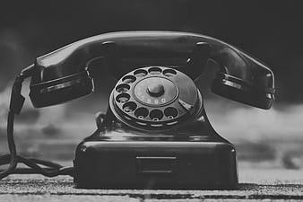 Vintage Black Rotary Telephone on Textured Surface