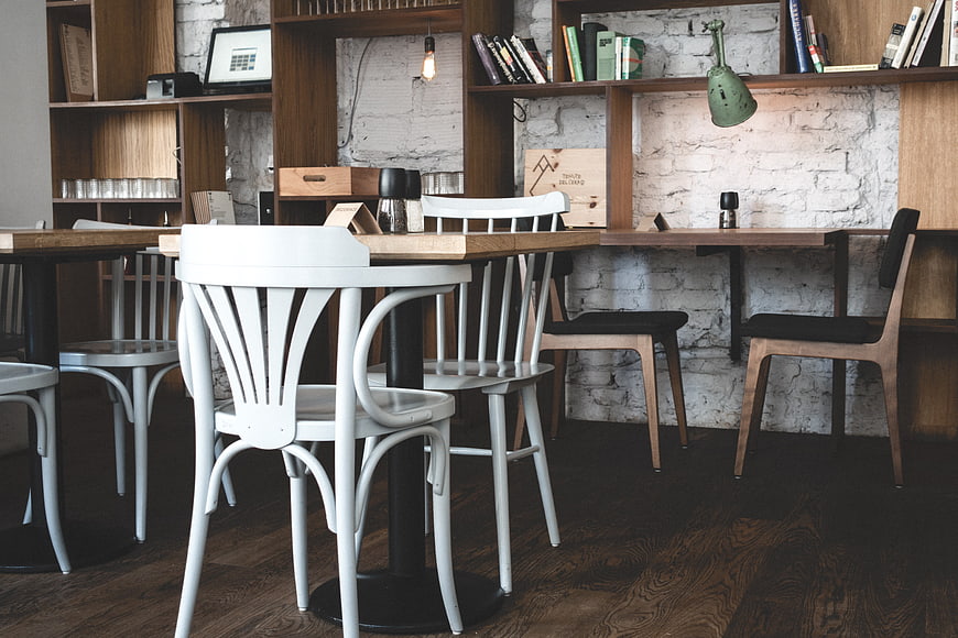Modern Hip Bistro Interior with Wooden Furniture and White Brick