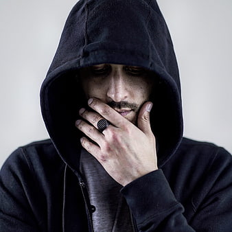 Moody Portrait of Man in Black Hoodie with Ring