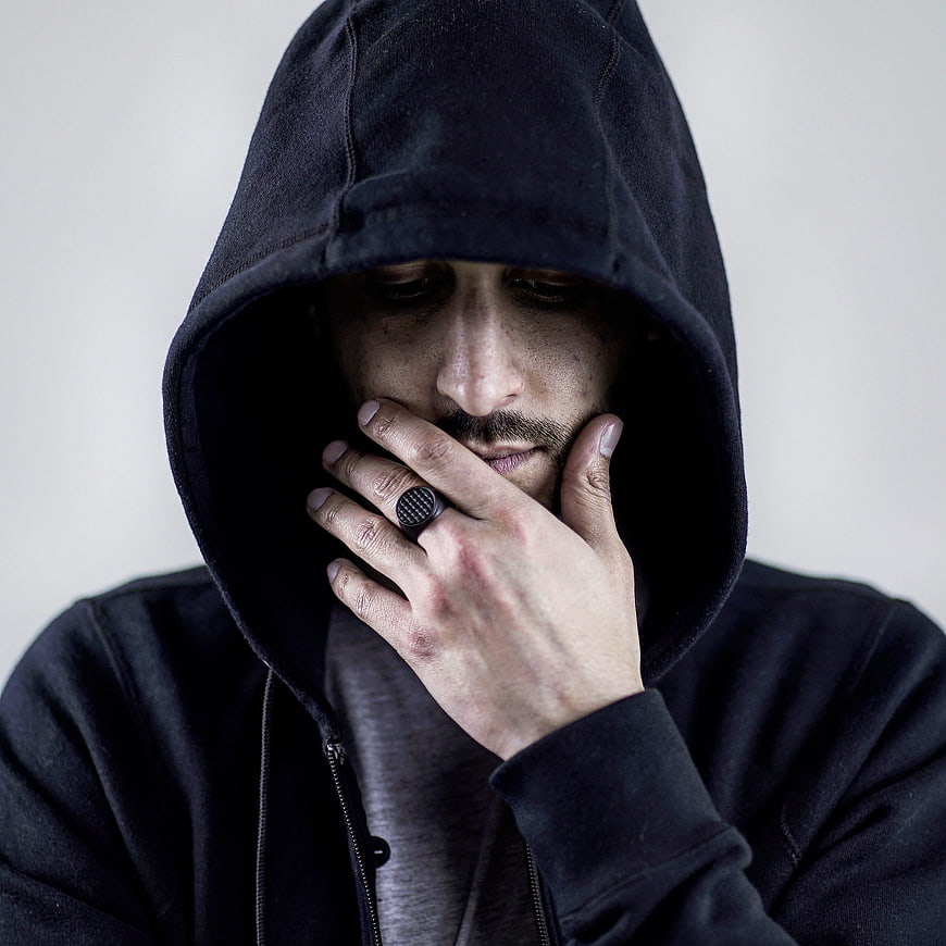 Moody Portrait of Man in Black Hoodie with Ring