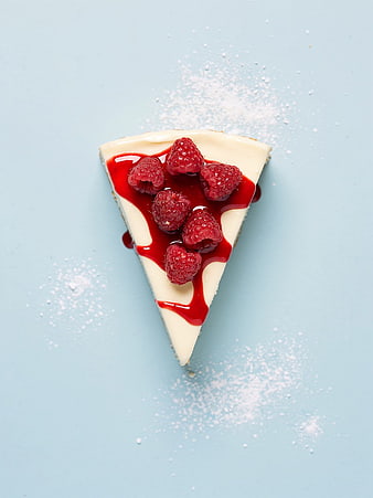 Raspberry Cheesecake Slice on Blue Background