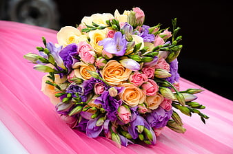Vibrant Wedding Bouquet With Roses And Lilies On Pink Fabric