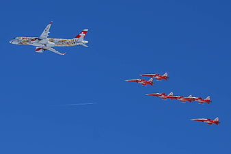 Swiss Airplane and Patrouille Suisse Jets Flying in Formation