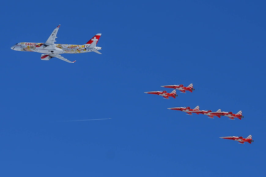 Swiss Airplane and Patrouille Suisse Jets Flying in Formation