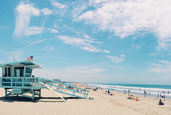 Turquoise Lifeguard Tower On Sunny Beach With American Flag