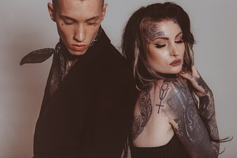 Edgy Tattooed Couple in Dark Studio Portrait