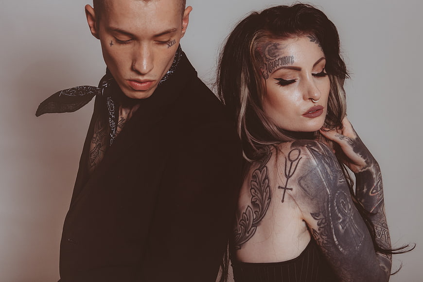 Edgy Tattooed Couple in Dark Studio Portrait