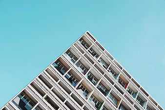 Low angle view of modern apartment building against blue sky