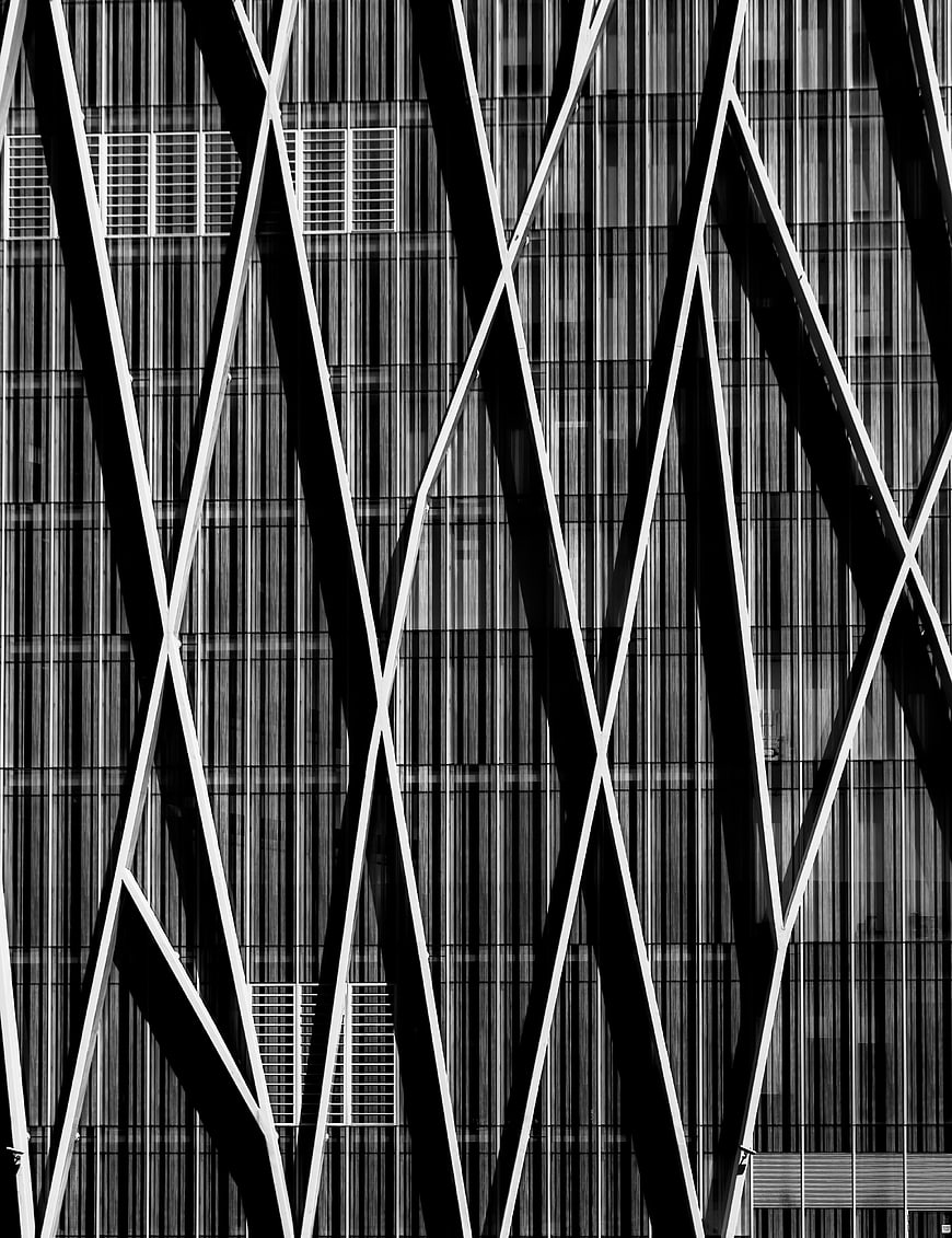 Black and white abstract modern building facade with diagonal beams