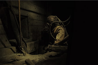 Historical miner in vintage protective suit and helmet
