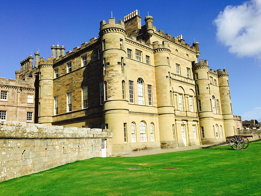 Edinburgh Castle exterior with green lawn and blue sky