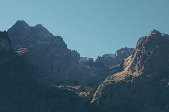 Dramatic Mountain Peaks with Blue Sky and Sunlit Ridges