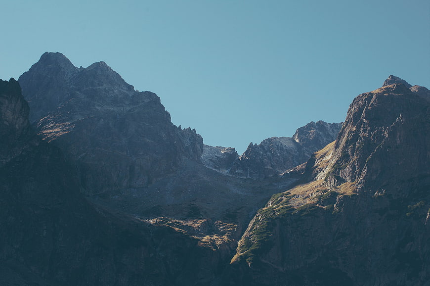 Dramatic Mountain Peaks with Blue Sky and Sunlit Ridges