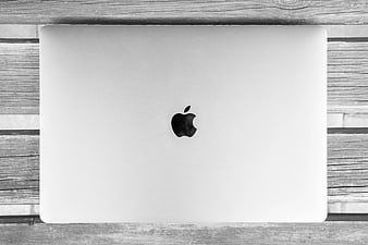 Top view of closed silver laptop on wooden background