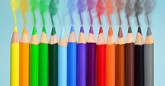 Colorful pencils with smoke rising from tips on blue background