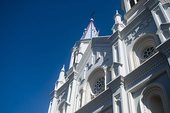 White Gothic Church Architecture Against Blue Sky