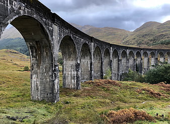 Glennfinnan Viaduct in the Scottish Highlands with dramatic overcast skies