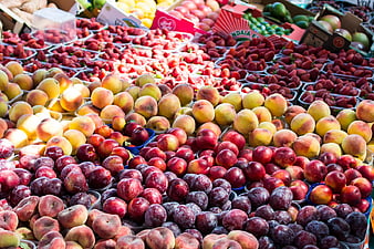 Fresh Summer Fruit Market Display with Peaches and Plums
