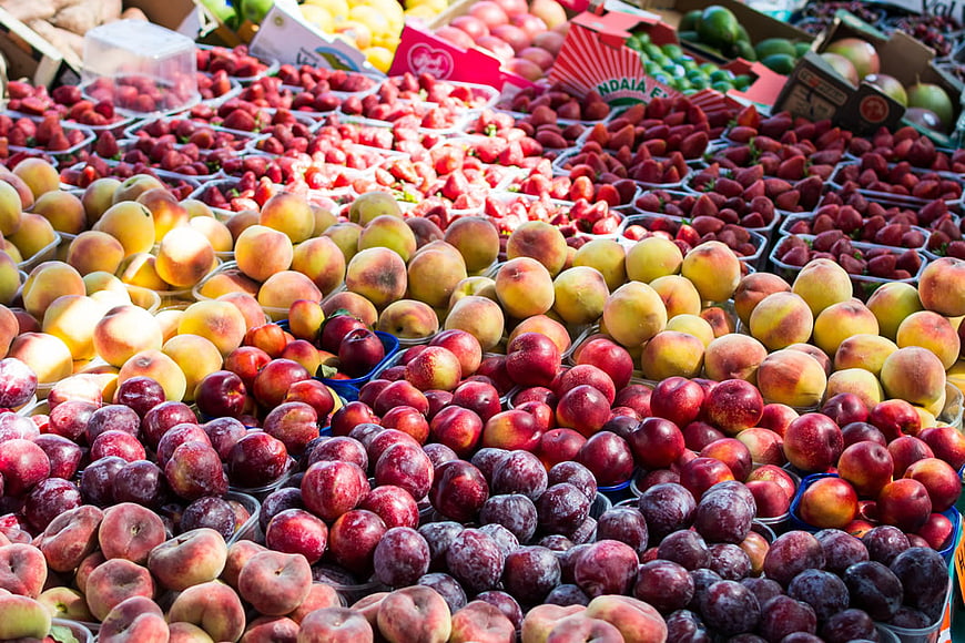 Fresh Summer Fruit Market Display with Peaches and Plums