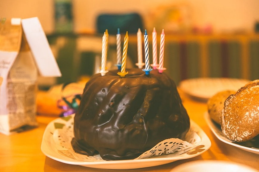 Chocolate Easter Cake with Candles on Wooden Table