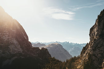 Majestic Mountain Valley Landscape with Sunlight and Forest