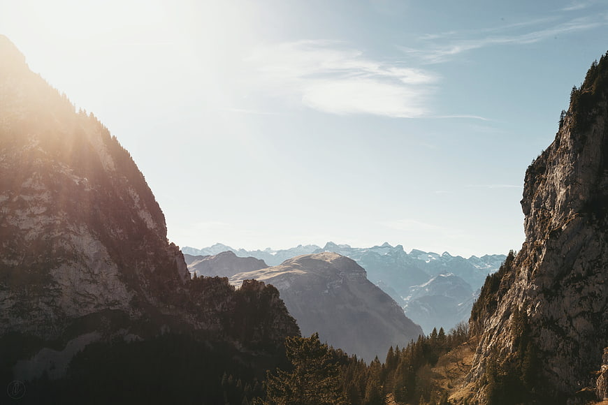 Majestic Mountain Valley Landscape with Sunlight and Forest