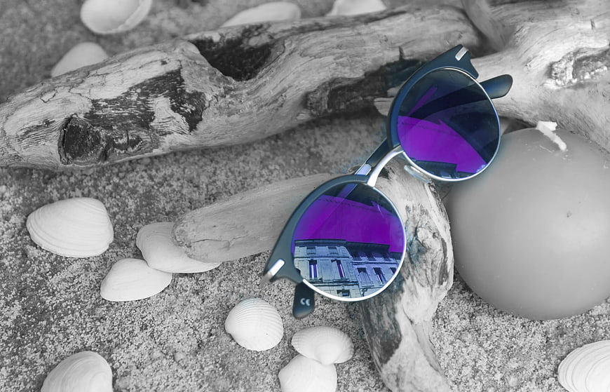 Reflective Sunglasses on Driftwood and Seashells