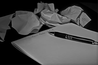 Black and white pen on paper with crumpled notes