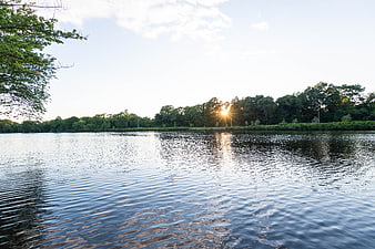 Serene Lake Sunset with Sunlight Reflection on Water