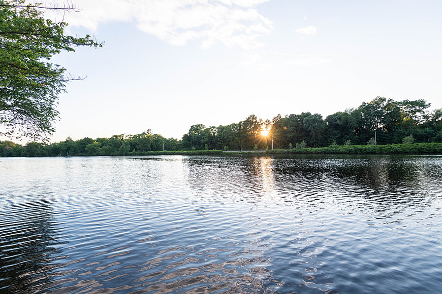 Serene Lake Sunset with Sunlight Reflection on Water