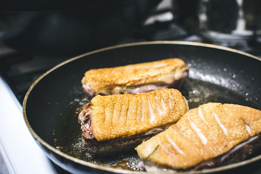 Pan-Fried Duck Breast with Scored Skin Cooking in Skillet
