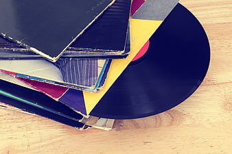 Stack of vintage vinyl records on wooden table